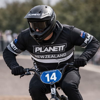 Black planett helmet with white branding and dark visor