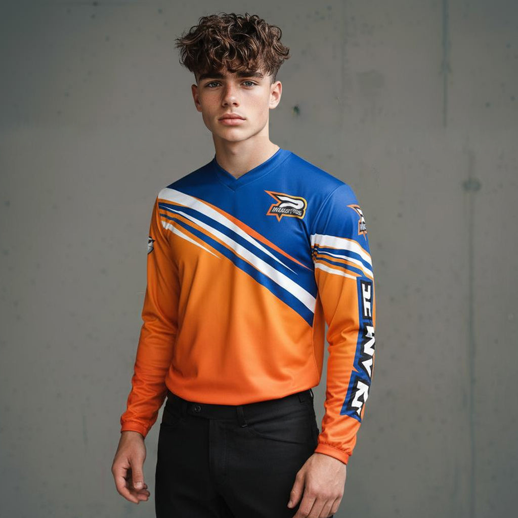 A young man wearing an orange and blue long-sleeved athletic shirt with white diagonal stripes.