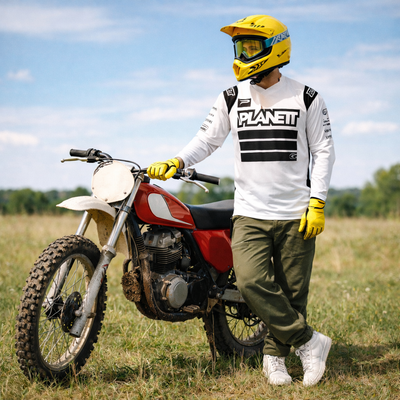 Red and white vintage dirt bike with a rugged, off-road design.