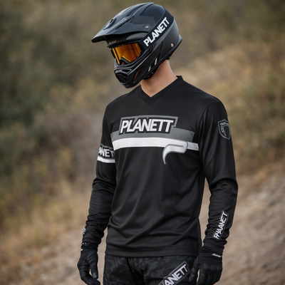 Black planett motocross jersey with white and gray accents, featuring a bold logo across the chest and matching branding on sleeves.