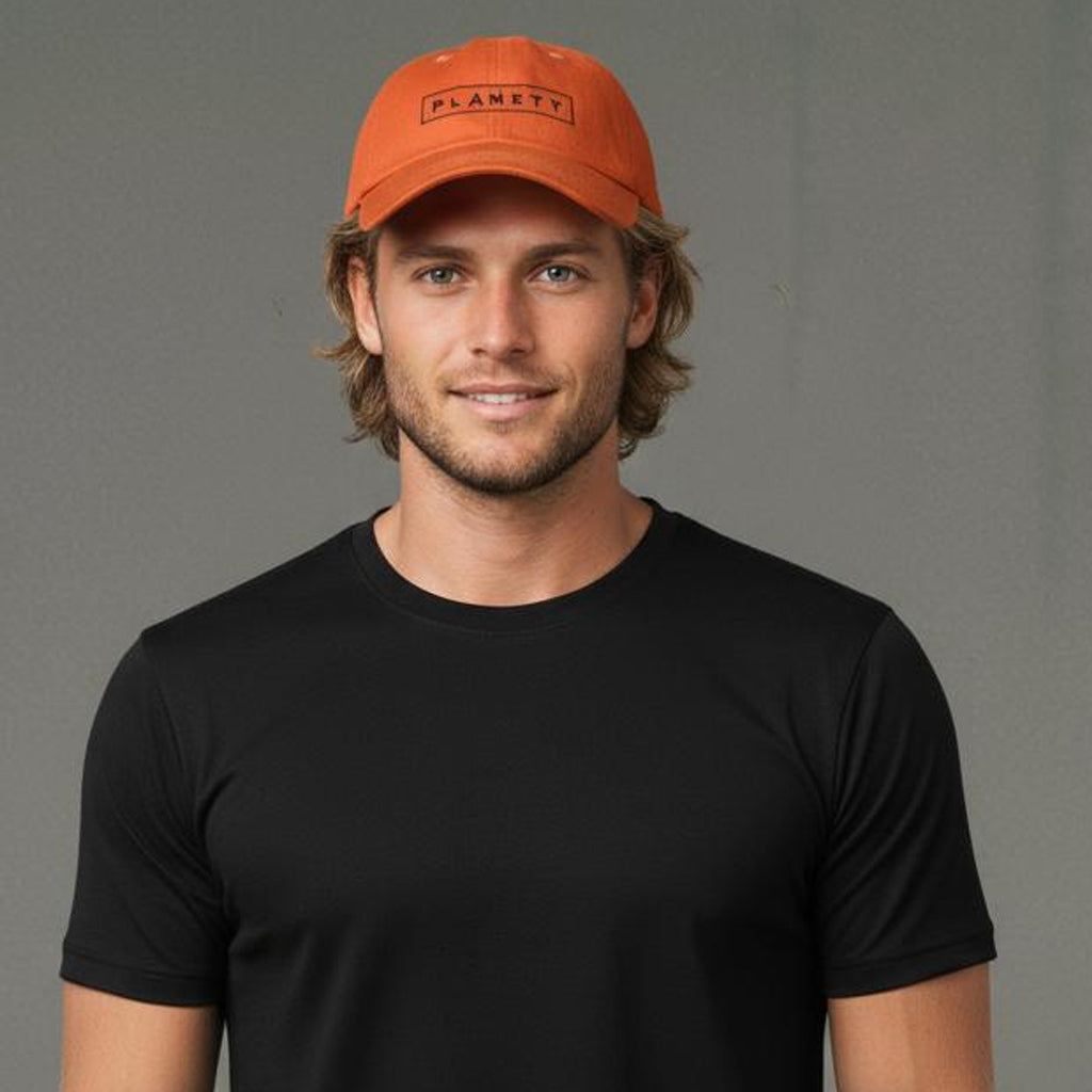 Orange baseball cap with ’planet’ text, cotton material.