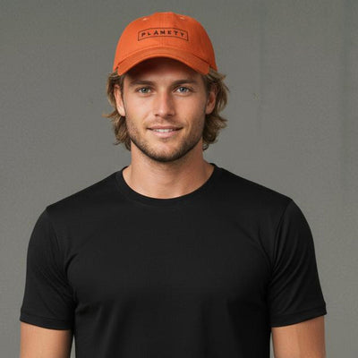 Orange baseball cap with ’planet’ text, cotton material.