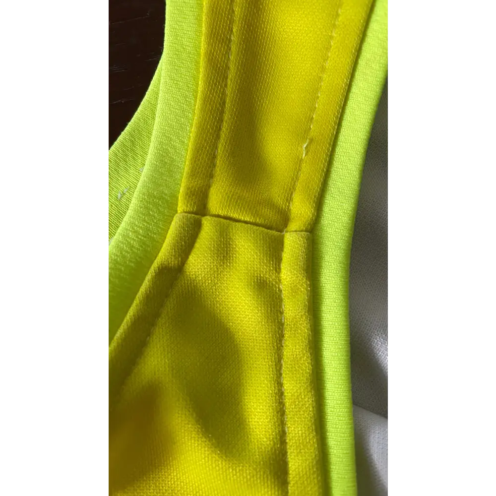 Bright yellow fabric with seams.