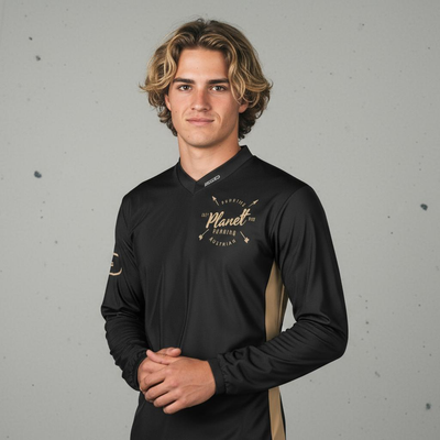 A young man with light brown, wavy hair wearing a black long-sleeved shirt with tan side panels.