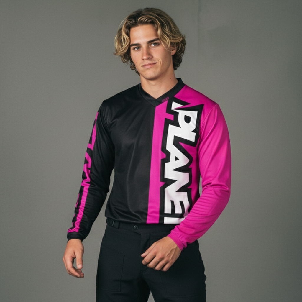 A long-sleeved athletic jersey, half black and half bright pink, with vertical white lettering.