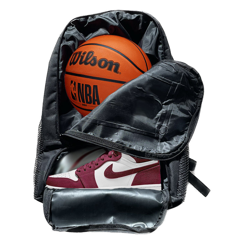 Black backpack with mesh side pockets and a zippered compartment containing an orange wilson nba basketball and maroon and white nike air jordan 1 sneaker.