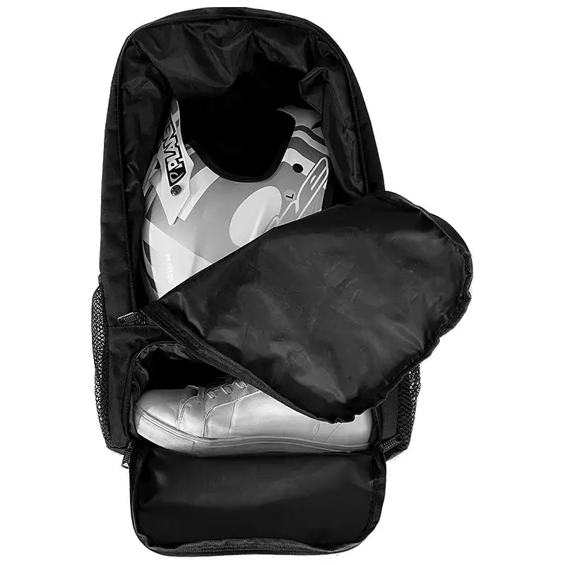Open black backpack with helmet and shoes.