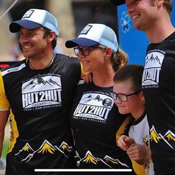 Group wearing matching shirts and hats.