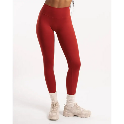 Red leggings with beige sneakers.