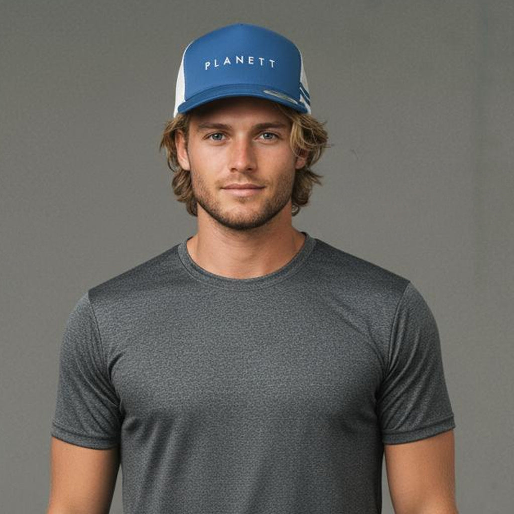 A man wearing a blue and white trucker hat and a dark gray short-sleeved athletic shirt.