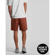 Man wearing brown shorts and white t-shirt.