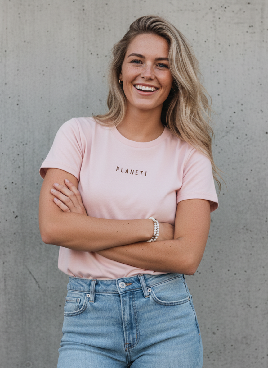 A woman in a light pink t-shirt and light wash jeans.