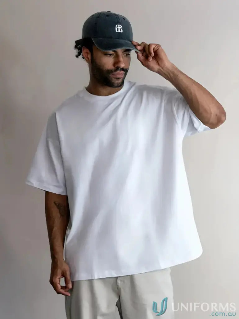 White oversized t-shirt with black cap and logo.