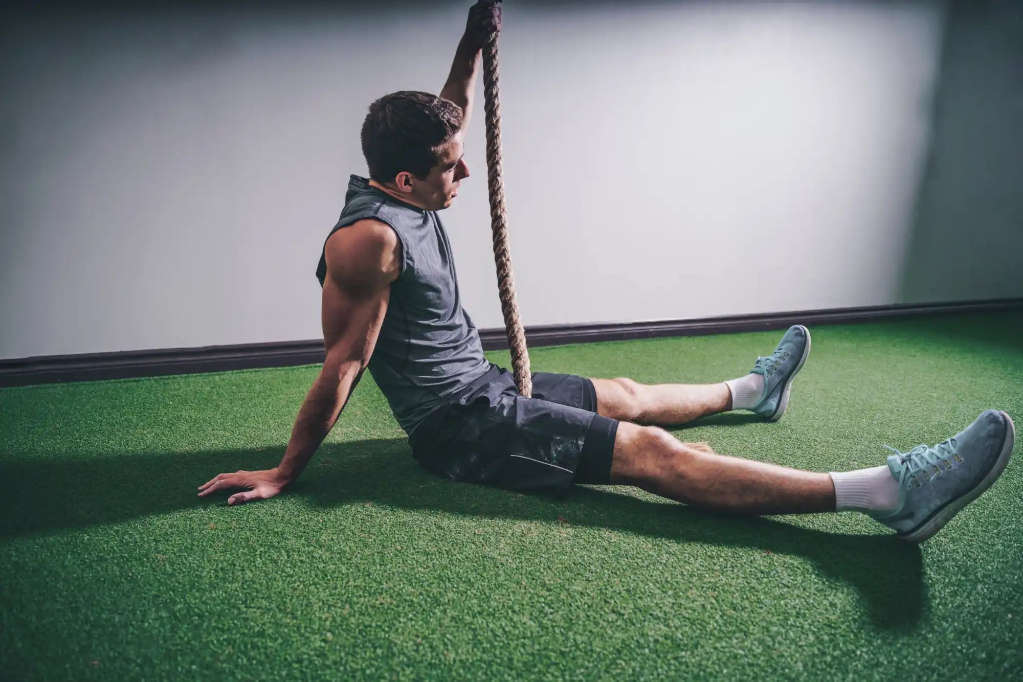 Man resting after rope climb.