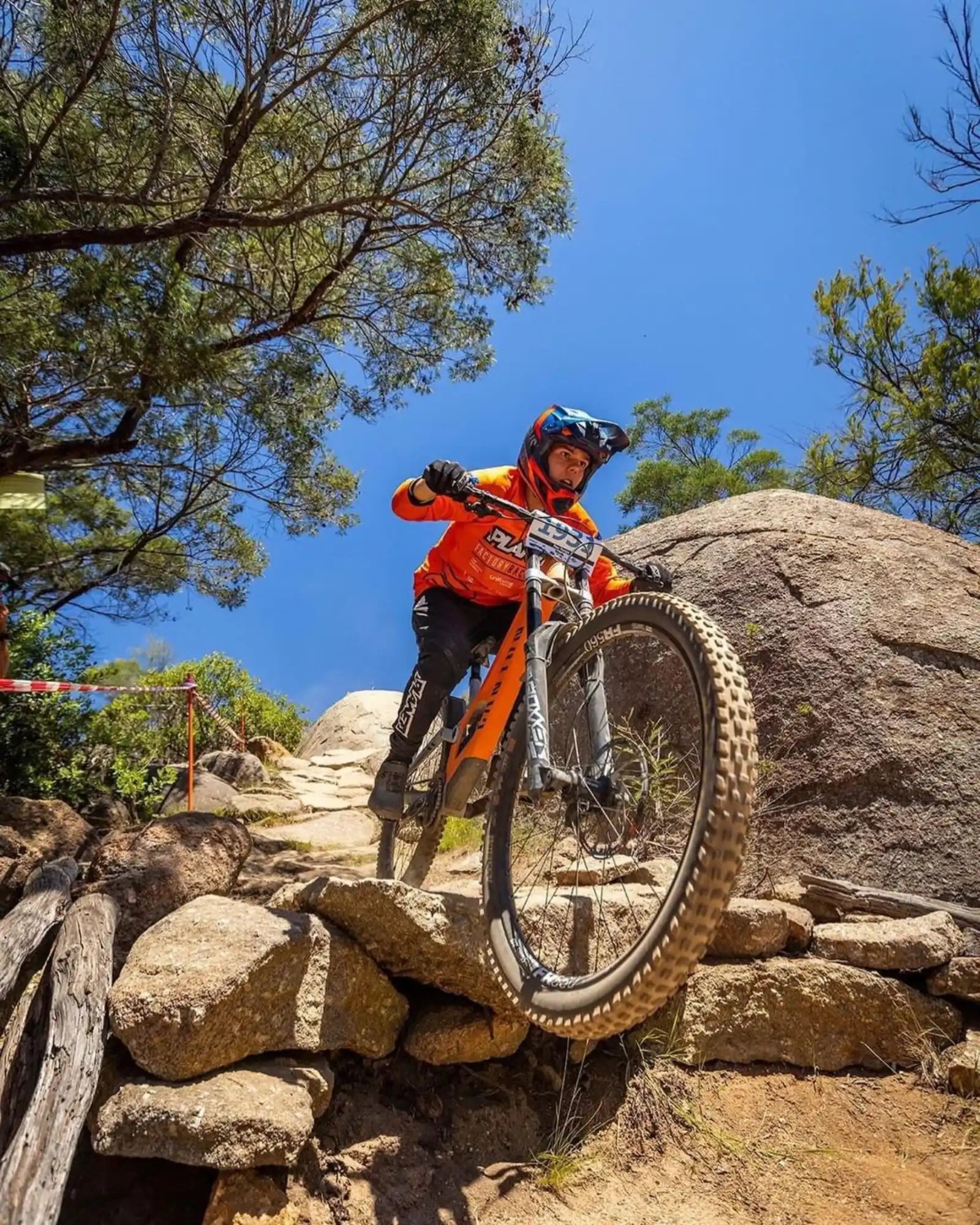 Mountain biker riding over rocks.