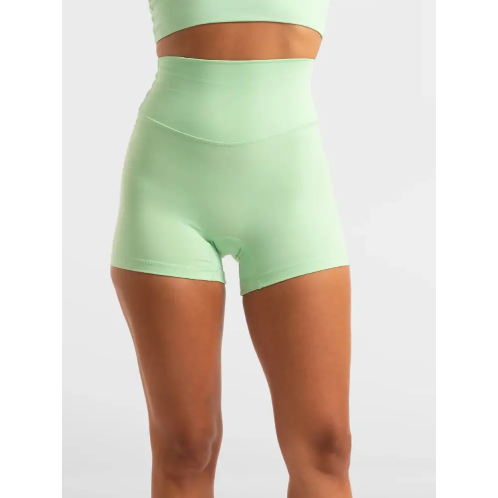Mint green high-waisted athletic shorts.