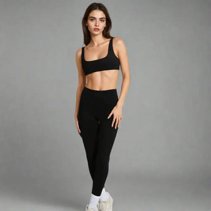 Woman in black sports bra and leggings.
