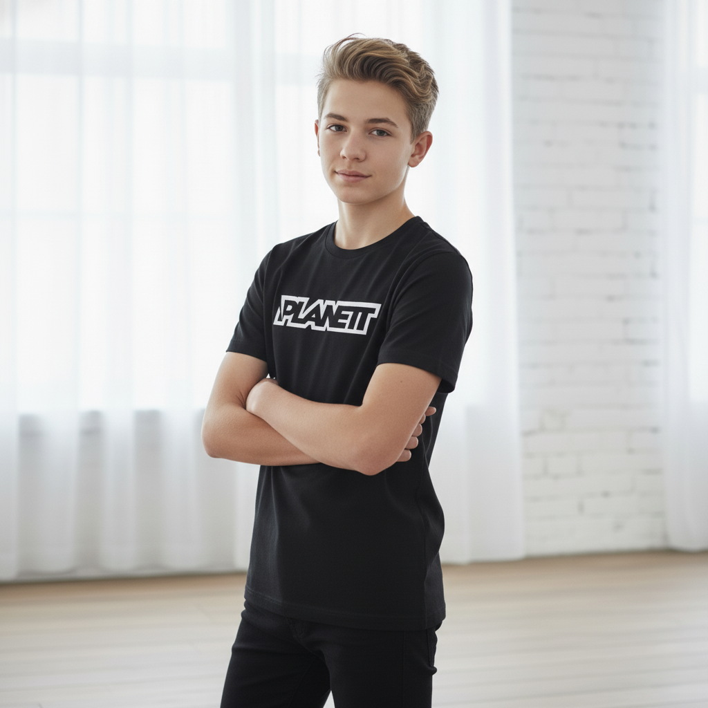 A young male model wearing a black t-shirt and black pants.