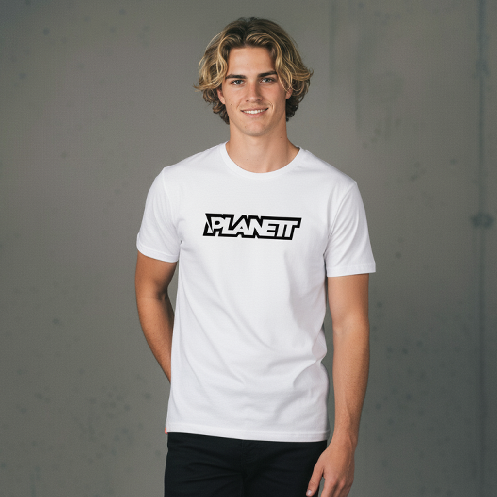 A smiling young man with shoulder-length blonde hair wearing a white crew-neck t-shirt with ’PLANETT’ in black outline lettering and black pants.