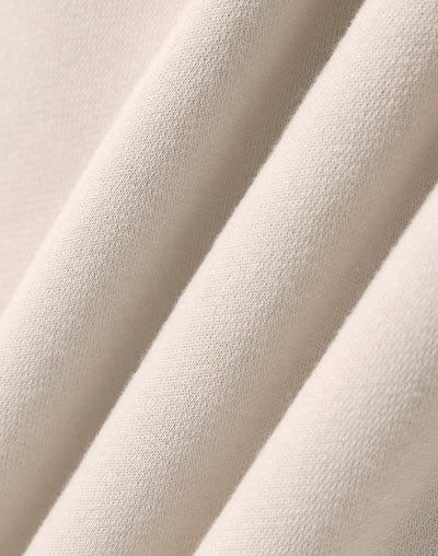 Beige textured fabric folds.