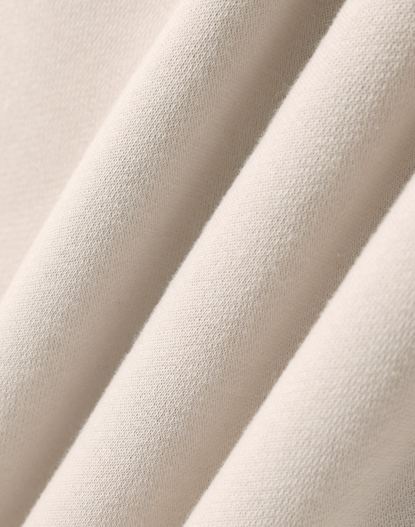 Beige textured fabric folds.