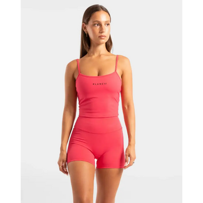 Woman’s pink athletic top and shorts set.
