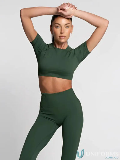 Green leggings with high waistband and matching crop top set, likely made of spandex or similar material for fitness wear.