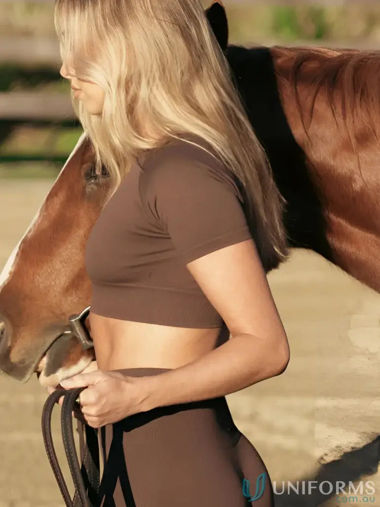 Brown short-sleeved crop top with mesh paneling and elastic waistband.
