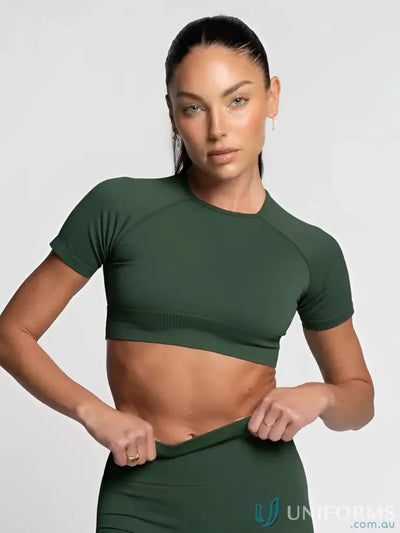 Olive green cropped athletic top with short sleeves and ribbed fabric.