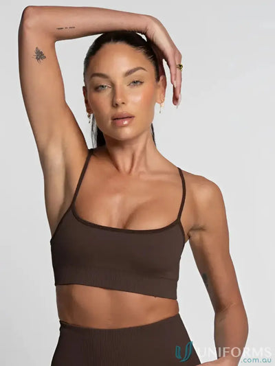Brown seamless sports bra with thin straps and a scoop neckline.