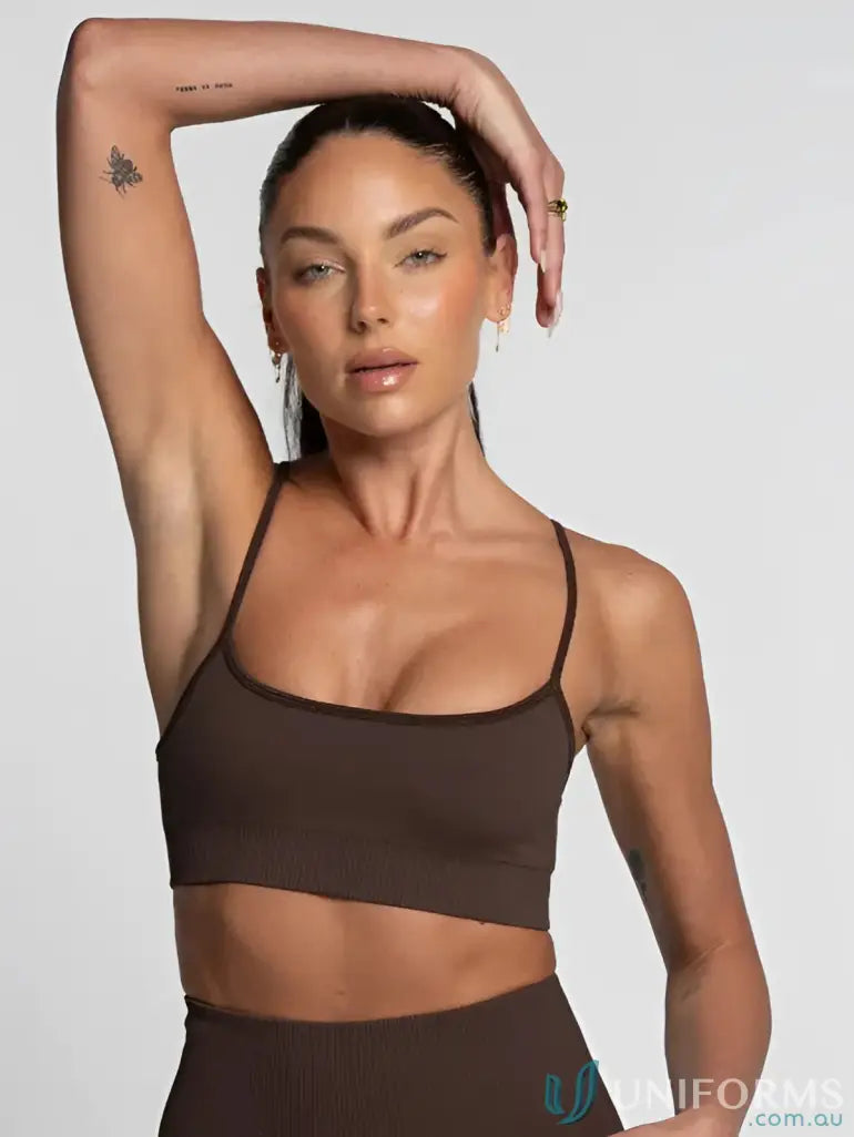Brown seamless sports bra with thin straps and a scoop neckline.