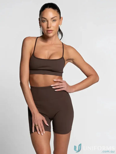 Brown seamless athletic set with high-waisted shorts and matching sports bra, likely from a fitness brand.