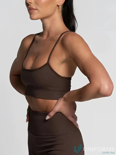 Brown sports bra with teal accents and adjustable straps.