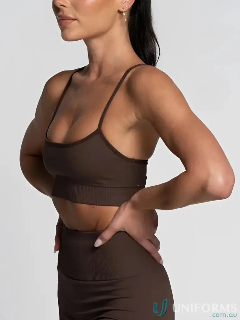 Brown sports bra with teal accents and adjustable straps.