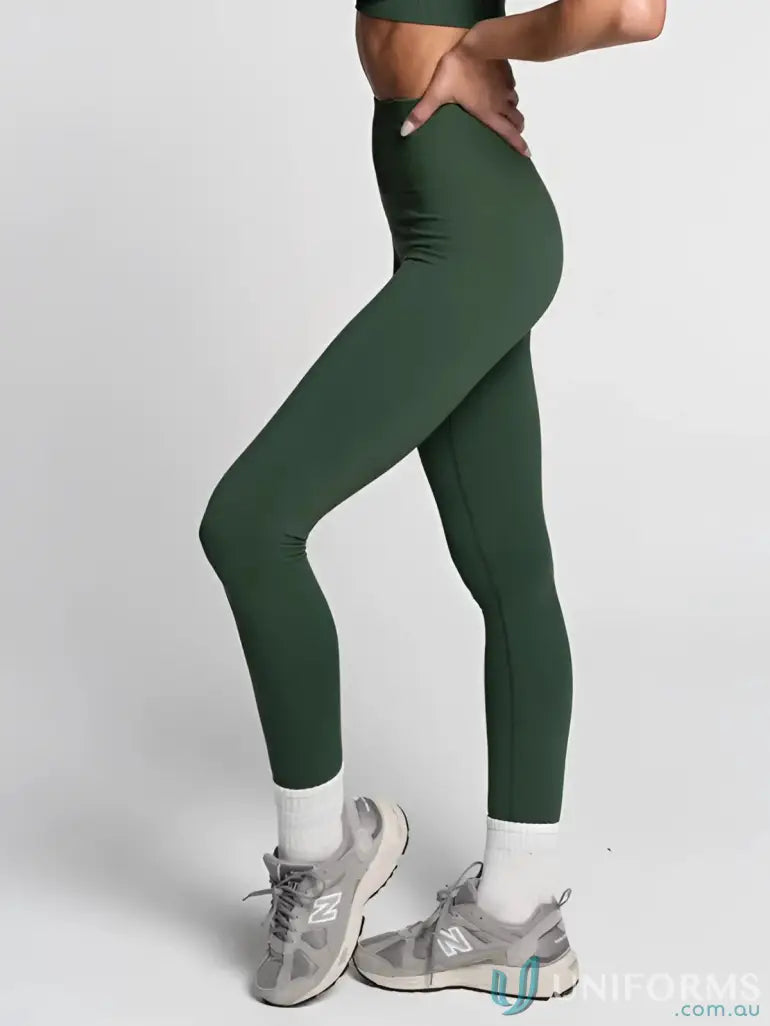 Green leggings with white socks and gray sneakers.