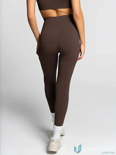 Brown leggings with high waist and seamless design, likely made of spandex or similar material.