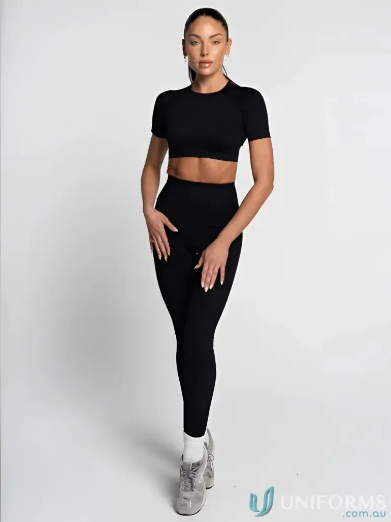 Black leggings with a ribbed texture and elastic waistband, designed for comfort and style.