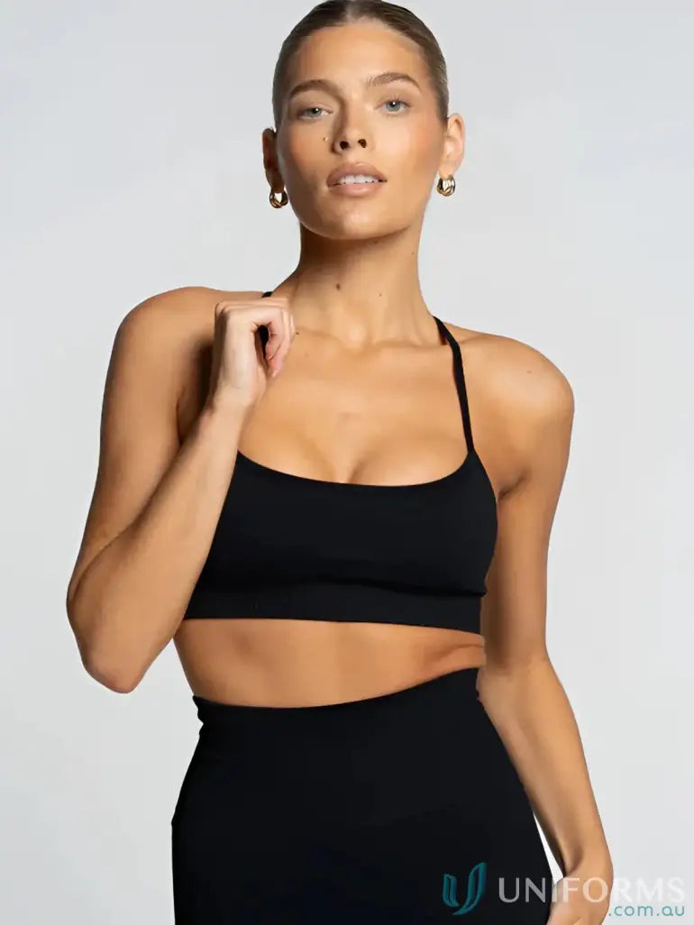 Black halter neck crop top with thin straps and a sleek design.