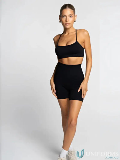 Black athletic two-piece set with matching sports bra and shorts, made of stretchy fabric for comfort.