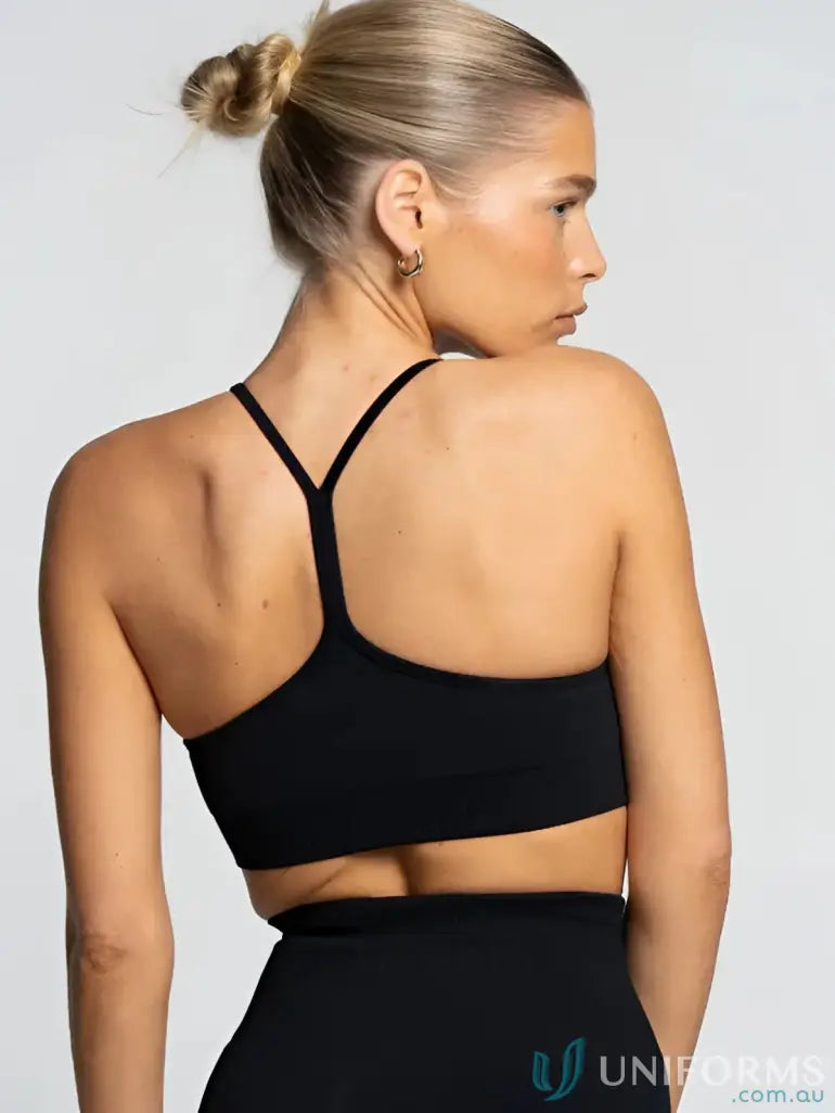 Black sports bra with crisscross back design and thin straps.