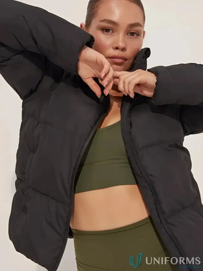 Black puffer jacket with olive green sports bra and leggings.
