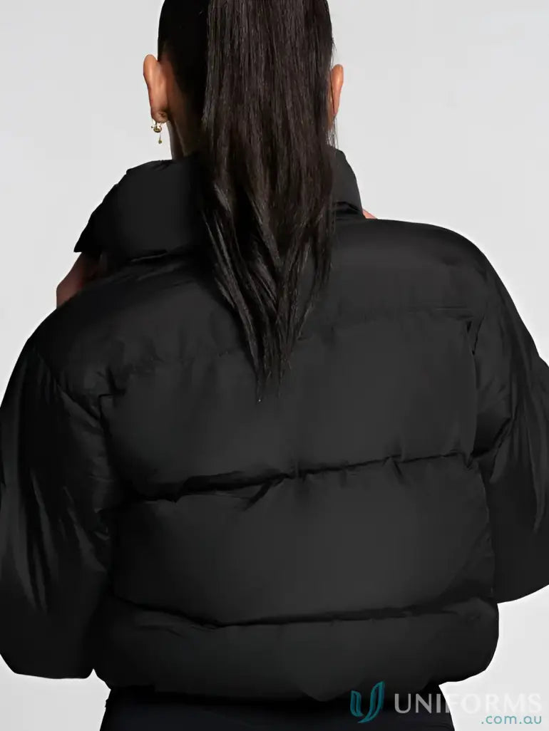 Black puffer jacket with hood and wide sleeves, likely made of synthetic material for warmth.