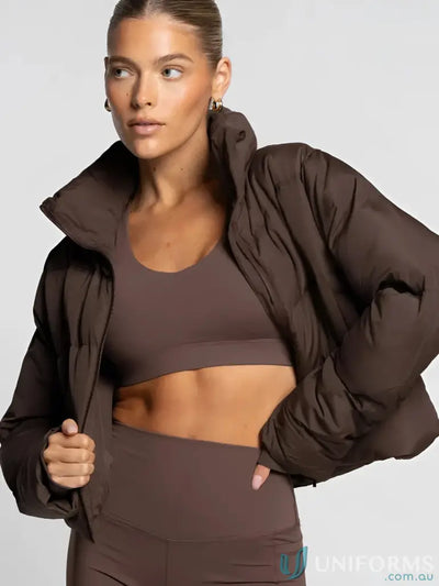 Brown puffer jacket with high collar and long sleeves, made of quilted material.