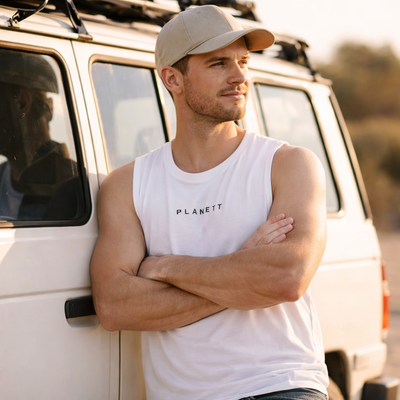 White sleeveless tank top with ’planett’ printed in black uppercase letters across the chest.