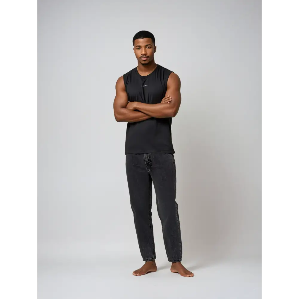 Man in black sleeveless shirt and jeans.