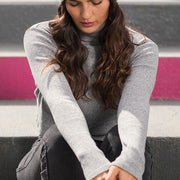 Woman wearing a gray beanie.