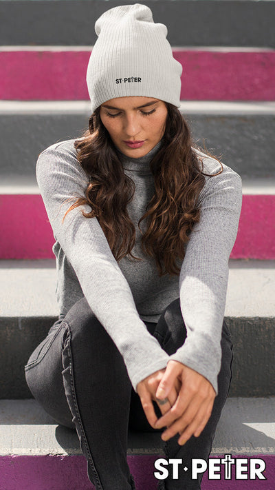 Woman wearing a gray beanie.