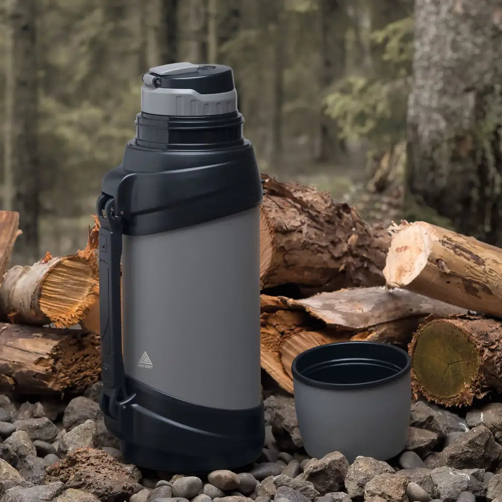 Gray and black thermos with cup.