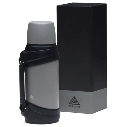 Gray thermos with black handle and box.