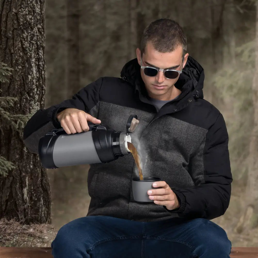 Man pouring hot beverage from thermos.